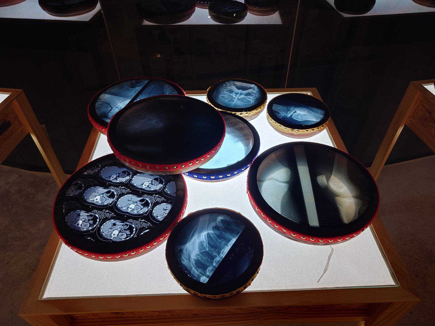 Set of kompang instruments with x-ray skin  on a wooden stand with a dark background